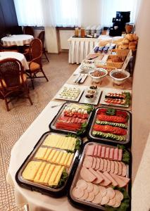 a long table with different types of food on it at Hotel Vector in Tarnowo Podgórne