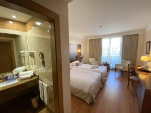 Postel nebo postele na pokoji v ubytování Hotel Montera Plaza