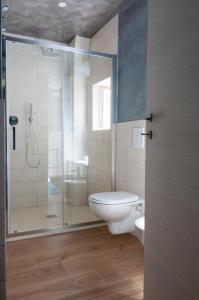 a bathroom with a toilet and a glass shower at Casa Nocchi in Lucca +10 photos