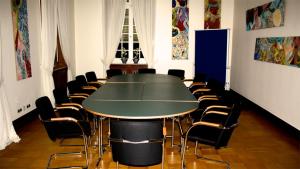 a conference room with a table and chairs at Tagungsvilla Weißer Berg in Neuwied