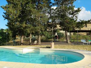 a small swimming pool in a yard with trees at Apartment Le Colmate-4 by Interhome in Montecatini Val di Cecina