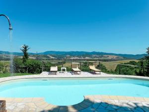 a swimming pool with a view of the mountains at Apartment Le Colmate-4 by Interhome in Montecatini Val di Cecina