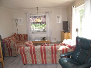 a living room with two couches and a tv at Holiday Home Trollsjö Stegeborg - OST102 by Interhome in Norrkrog
