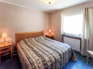 a bedroom with a bed and a window at Holiday Home Trollsjö Stegeborg by Interhome in Norrkrog