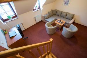 an overhead view of a living room with a couch and a table at Penzion U řeky in Vojkovice