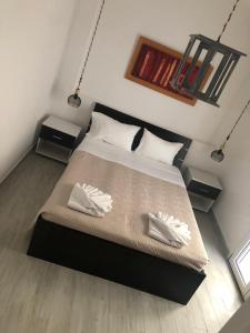 a bedroom with a large bed with two white shoes at Iliana Sea Side House in Elounda