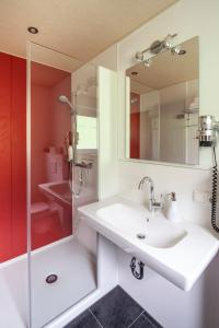 a bathroom with a sink and a shower at Hotel Garni Brigitte in Bürserberg