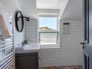 a bathroom with a sink and a window at Macs Townhouse Dungarvan in Dungarvan +52 photos