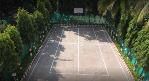 an overhead view of a tennis court with trees at Madhuvan Farm cottage in Alibaug