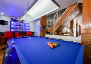 a pool table in a room with a bar at Sun & Beach in Pattaya South