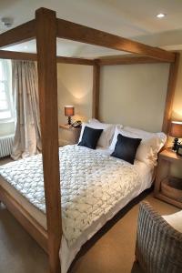 a bedroom with a large bed and a large window at The Punch Bowl Inn in Kendal