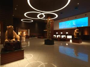 a lobby with statues of animals and a chandelier at Lake Akan Tsuruga Wings in Akankohan