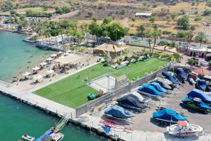 an aerial view of a marina with boats and a park at South Beach Kinnereth in Tiberias