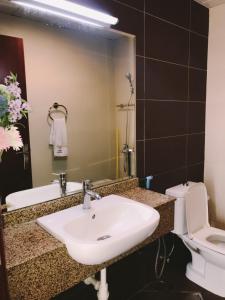 a bathroom with a sink and a toilet and a mirror at Deira Partition room in Dubai