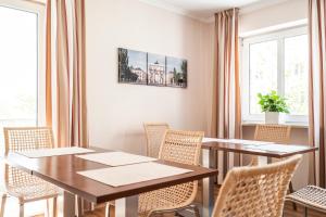 a dining room with tables and chairs and windows at Flatista Boutique Hotel - Self Check-in in Munich