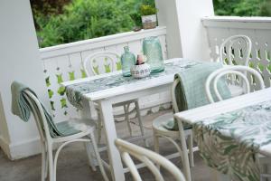 a white table and chairs on a porch at Villa Bella Vista - Apartment Blue in Pörtschach am Wörthersee