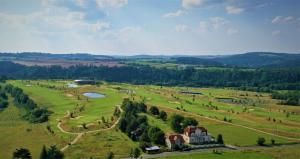 an aerial view of a large field with a house and trees at Apartmány Vila Mánička in Kácov