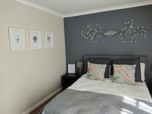 a bedroom with a bed with two pillows at Palm Beach Guesthouse in Port Elizabeth