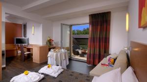a living room with a couch and a table at Relais Bellaria Hotel & Congressi in Bologna