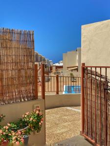 a balcony of a building with a fence and flowers at Los Cristianos 4 Bed Townhouse in Los Cristianos