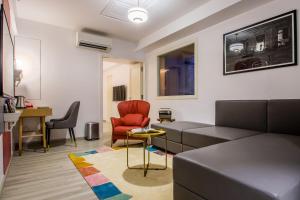 a living room with a couch and a table and chairs at T24 Retro in Mumbai