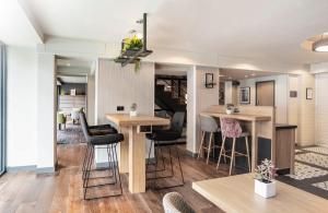 a kitchen that has a table and chairs in it at Point A Hotel London Paddington in London