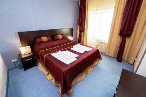 a hotel room with a bed with towels on it at Malaya Bukhta Health Resort in Anapa