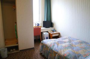 Een bed of bedden in een kamer bij Hotel Abest Aomori