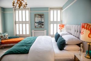 a bedroom with a large bed and a couch at Moore House in Hastings