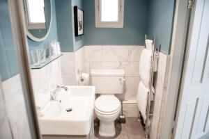 a bathroom with a white toilet and a sink at Moore House in Hastings