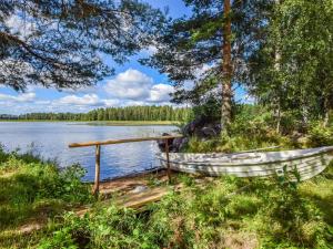 a boat on the shore of a lake at Holiday Home Lehtoranta by Interhome in Lankamaa
