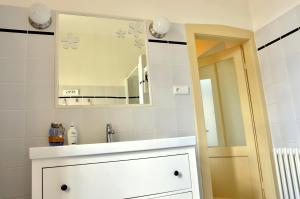 a bathroom with a sink and a mirror at Apartmány Vila Mánička in Kácov