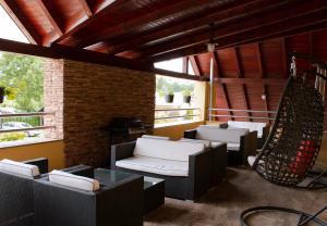 a patio with couches and a hammock in a building at Penzion Anesis - Apartmány in Turčianske Teplice