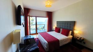 מיטה או מיטות בחדר ב-Hotel Miramar Sul