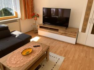 uma sala de estar com uma grande televisão de ecrã plano em Landhaus Viktoria em Imst