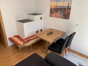 a living room with a wooden table and a chair at Landhaus Viktoria in Imst