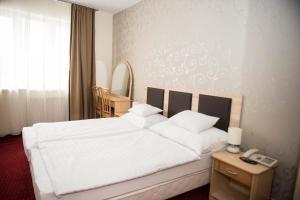 Posteľ alebo postele v izbe v ubytovaní Hozam Wellness és Apartman