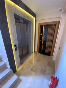 a hallway with stairs and a door with a fire hydrant at LONDON OTEL in Antalya