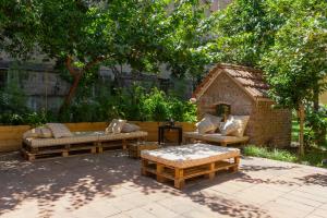 a patio with two couches and a dog house at HOPESTEL Secret Garden Napoli in Naples