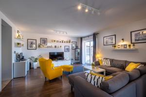 a living room with a couch and a yellow chair at Villa Gaga in Dubrovnik