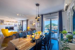 a dining room and living room with a table and chairs at Villa Gaga in Dubrovnik
