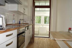 a kitchen with a sink and a stove top oven at Nette, geräumige Ferienwohnung in Wuppertal