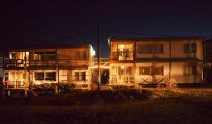 a two story apartment building at night at El Palafito in La Pedrera