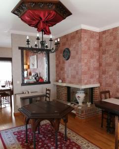 a living room with a table and a fireplace at Hotel De Pastorij in Leuven