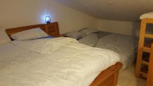 a bedroom with two beds and a light on the wall at Tignes 1800 in Tignes +4 photos