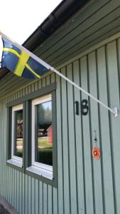 a flag hanging on the side of a building at Private room for rent in a villa with garden view in Älmhult