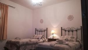 a bedroom with two beds and a lamp in it at Casa Ana, Fantásticas vistas a Frigiliana, el mar y la montaña in Frigiliana +45 photos