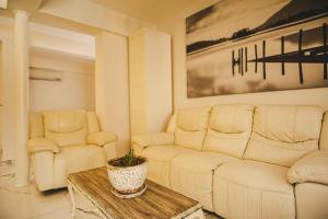 a living room with a couch and two chairs at Belsun Hotel in Beldibi