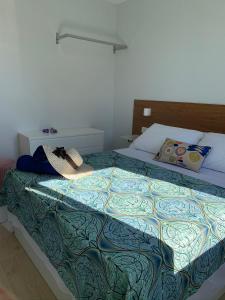 a bedroom with a bed with a colorful blanket at Sereíña Beach in Vigo +20 photos