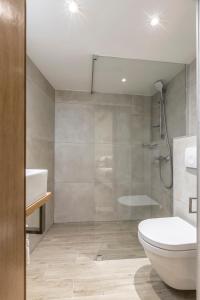 a bathroom with a shower and a toilet and a sink at Cosmijeva Luxury Rooms in Split